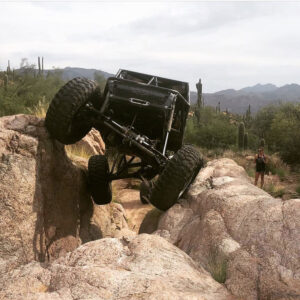 vehicle with large tires makes its way through big boulders in the desert Arizona Driveshaft & Differential Mesa Arizona