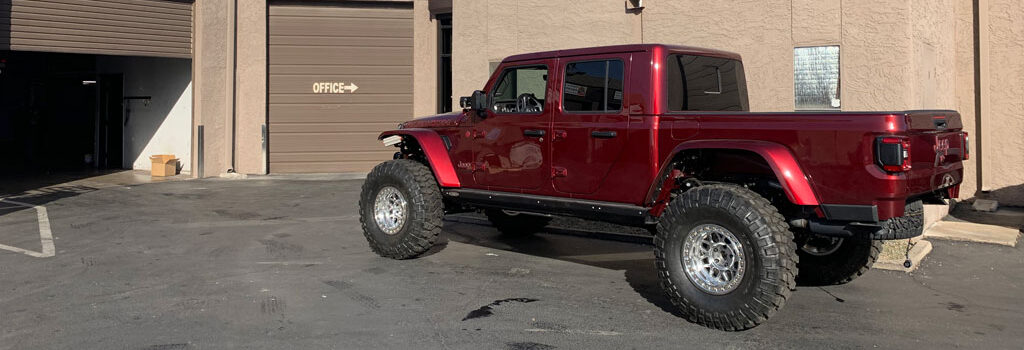 maroon Jeep truck has off road tires and driveshaft for the trails Arizona Driveshaft & Differential Mesa Arizona